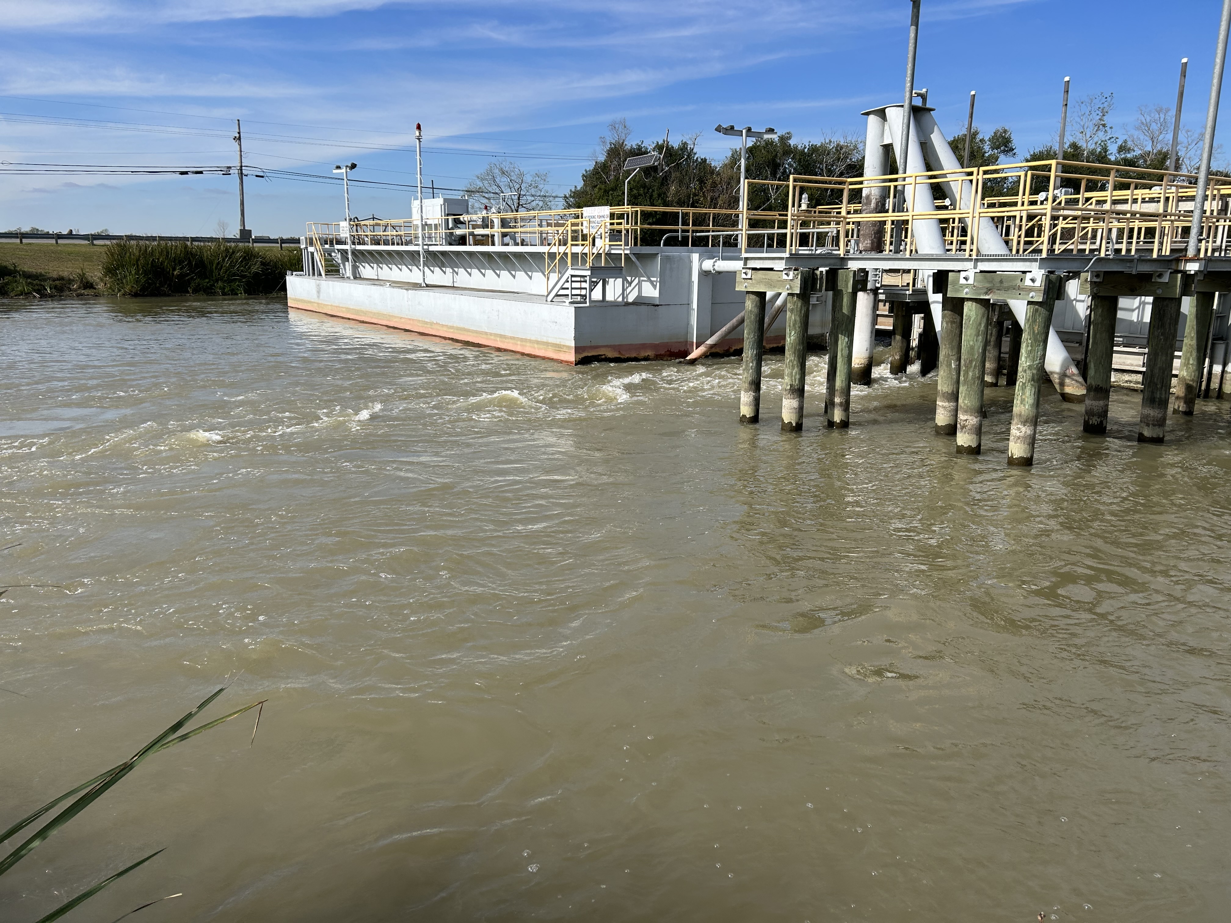 An industrial machine sits in the water. 